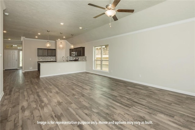 unfurnished living room with ceiling fan, sink, dark wood-type flooring, a textured ceiling, and ornamental molding