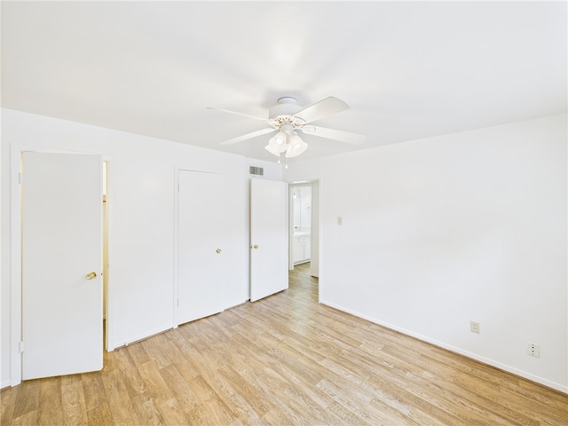 109 Wood St, Navasota, TX 77868 - unfurnished bedroom featuring light wood-style flooring, baseboards, and a ceiling fan