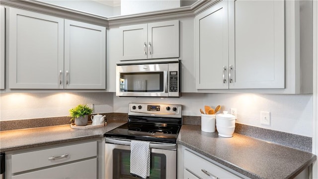 kitchen with dark countertops and appliances with stainless steel finishes