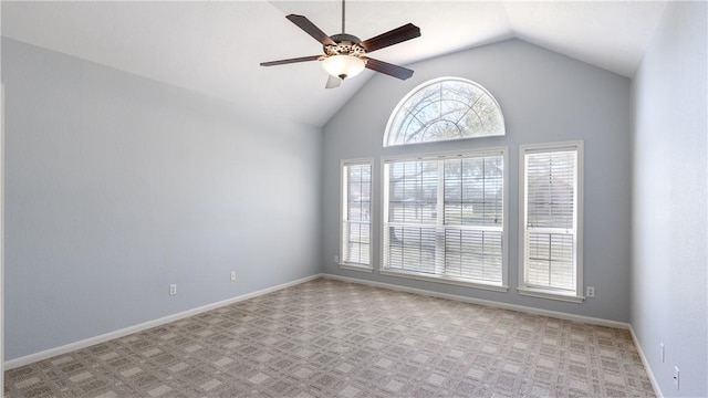 empty room with light carpet, ceiling fan, high vaulted ceiling, and baseboards