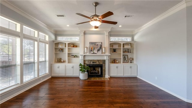 unfurnished living room featuring visible vents, baseboards, a fireplace, dark wood-type flooring, and crown molding