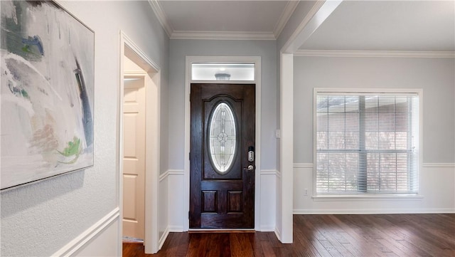 foyer featuring dark wood finished floors, baseboards, and ornamental molding