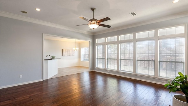 interior space with ornamental molding, ceiling fan with notable chandelier, and wood finished floors