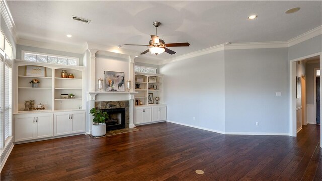 unfurnished living room featuring baseboards, dark wood-type flooring, crown molding, and a tile fireplace