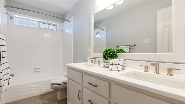 bathroom featuring tile patterned floors, toilet, shower / bath combo, and a sink