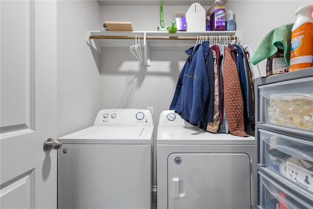 clothes washing area with washer and dryer and laundry area