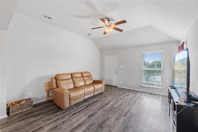 living area featuring vaulted ceiling, a ceiling fan, wood finished floors, and visible vents