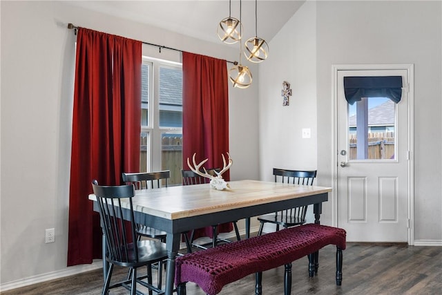 dining space with baseboards, a healthy amount of sunlight, and dark wood-style floors
