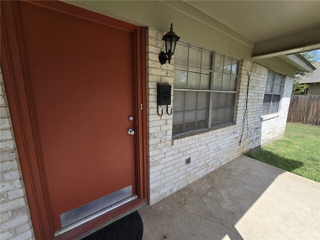 view of exterior entry featuring a porch