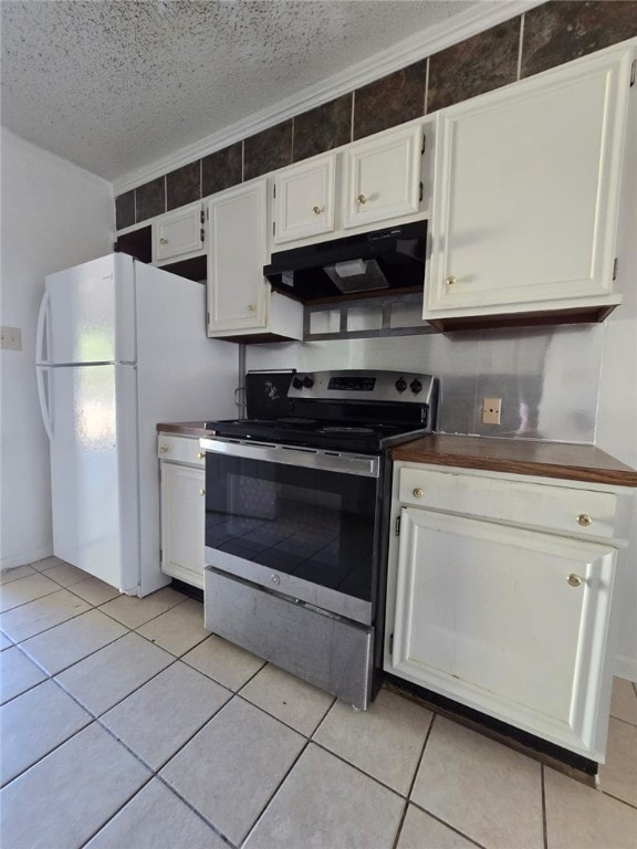 kitchen with electric stove, white cabinetry, light tile patterned flooring, and a textured ceiling