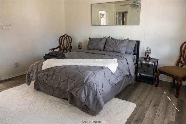 bedroom featuring ceiling fan and dark hardwood / wood-style flooring