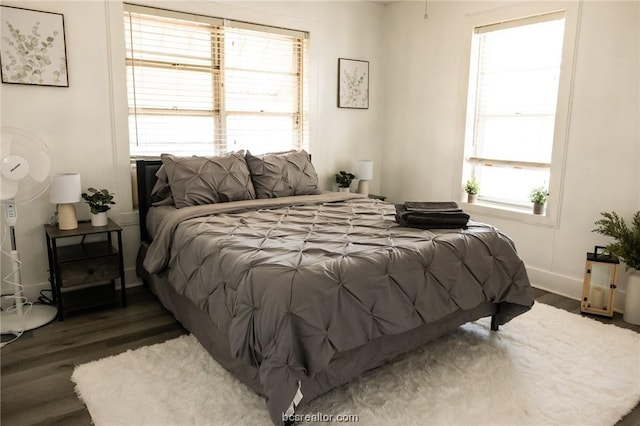 bedroom with dark wood-type flooring