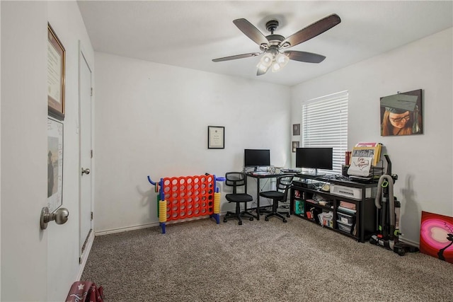 carpeted home office featuring ceiling fan