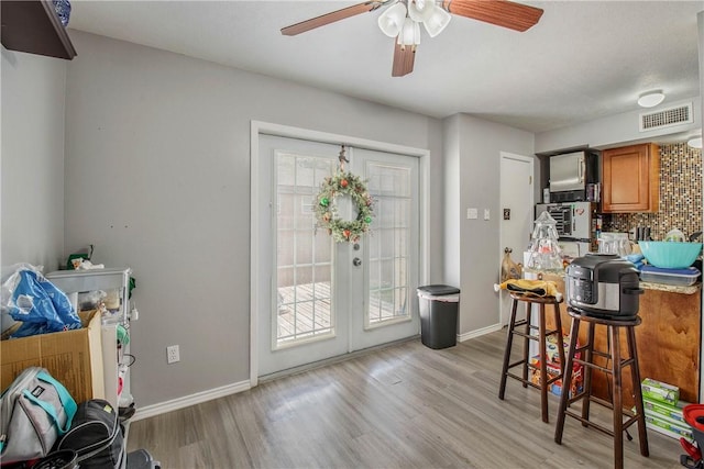 interior space with french doors and light hardwood / wood-style floors