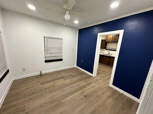 1303 Saunders St, Bryan, TX 77803 - empty room with a sink, ceiling fan, wood finished floors, crown molding, and recessed lighting