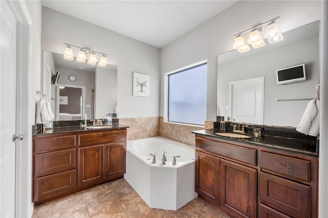 3901 Lienz Ln, College Station, TX 77845 - ensuite bathroom featuring a garden tub, two vanities, and tile patterned flooring