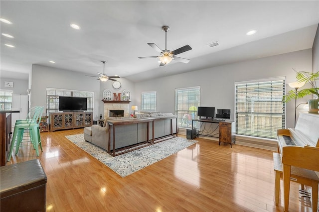 3901 Lienz Ln, College Station, TX 77845 - living area featuring ceiling fan, wood finished floors, a fireplace, plenty of natural light, and recessed lighting