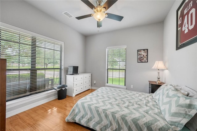 3901 Lienz Ln, College Station, TX 77845 - bedroom with multiple windows, light wood-type flooring, baseboards, and a ceiling fan