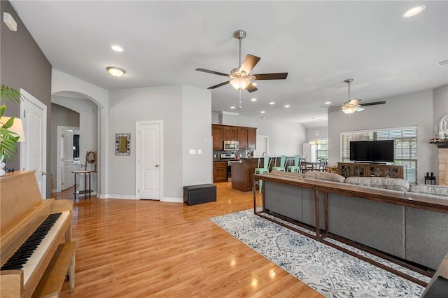 3901 Lienz Ln, College Station, TX 77845 - living area with ceiling fan, light wood-style flooring, arched walkways, recessed lighting, and baseboards