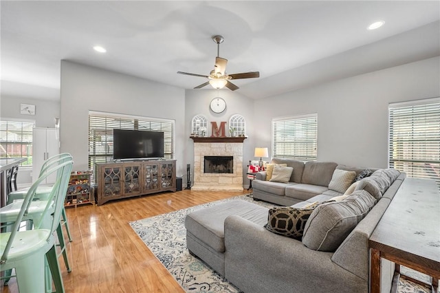 3901 Lienz Ln, College Station, TX 77845 - living room featuring a ceiling fan, light wood-style flooring, a stone fireplace, and recessed lighting