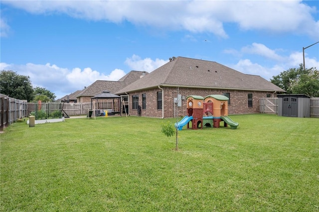 3901 Lienz Ln, College Station, TX 77845 - rear view of house with a gazebo, a playground, brick siding, and roof with shingles