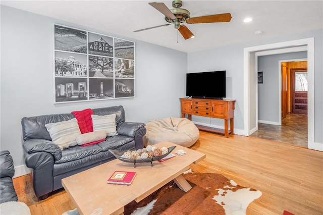 living room featuring ceiling fan and hardwood / wood-style floors