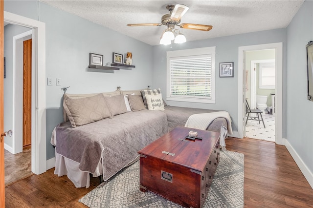 living room featuring hardwood / wood-style flooring, a textured ceiling, and ceiling fan