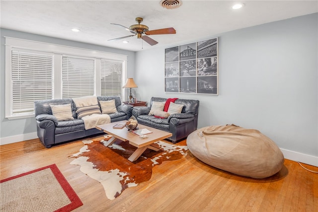 living room featuring ceiling fan and hardwood / wood-style floors