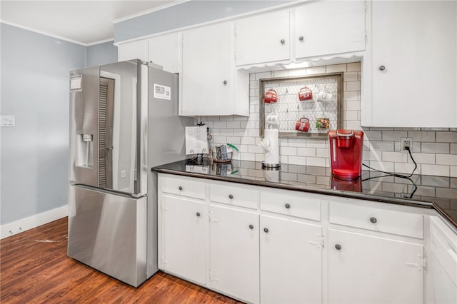 kitchen with wood-type flooring, white cabinets, decorative backsplash, ornamental molding, and stainless steel refrigerator with ice dispenser