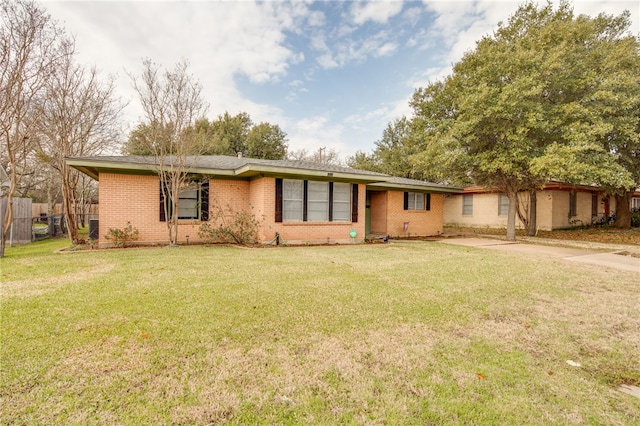 single story home with central AC and a front yard