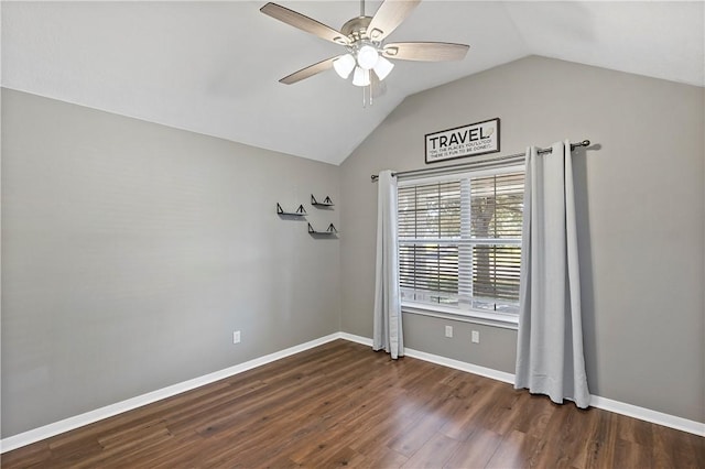 empty room with lofted ceiling, ceiling fan, and dark hardwood / wood-style floors