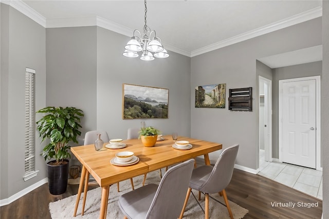 dining room featuring a chandelier, crown molding, and wood-type flooring