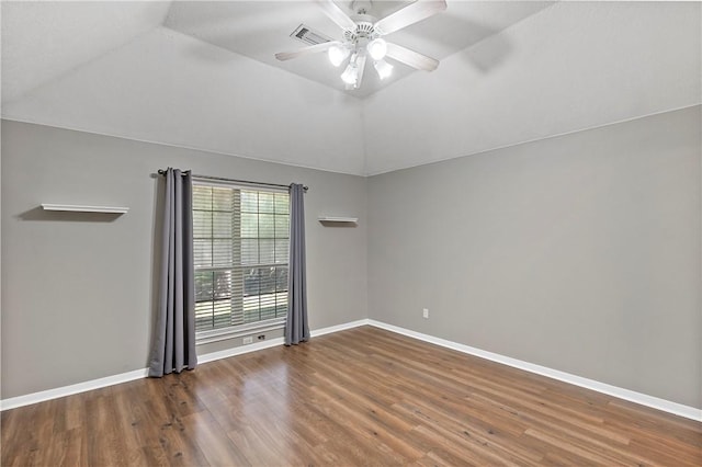 empty room featuring lofted ceiling, ceiling fan, and dark hardwood / wood-style floors