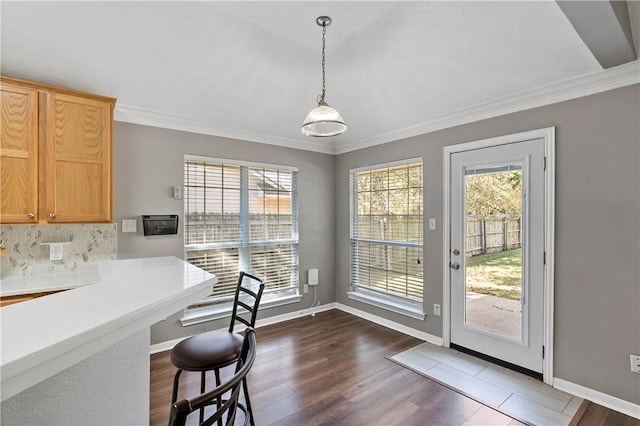 dining space with dark hardwood / wood-style flooring and ornamental molding