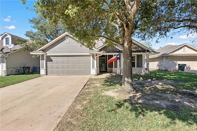 view of front of property featuring a front yard and a garage