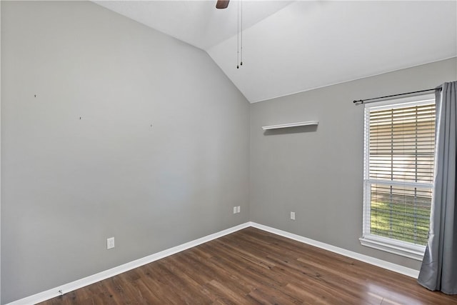 spare room with vaulted ceiling, ceiling fan, and dark wood-type flooring