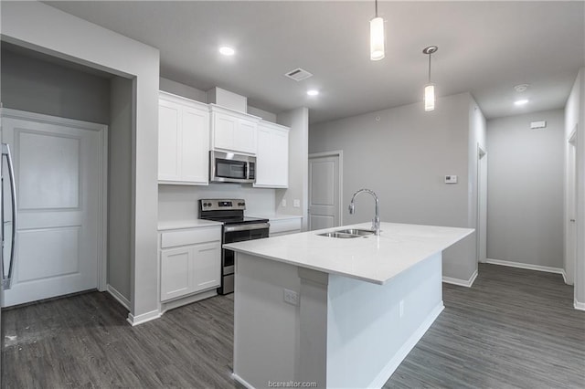 kitchen featuring stainless steel appliances, a center island with sink, white cabinets, and sink