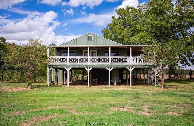 back of property featuring a lawn