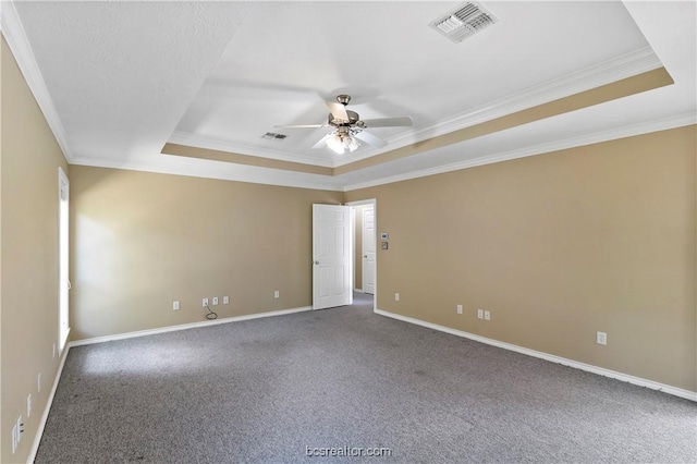 carpeted empty room with ceiling fan, a raised ceiling, and crown molding