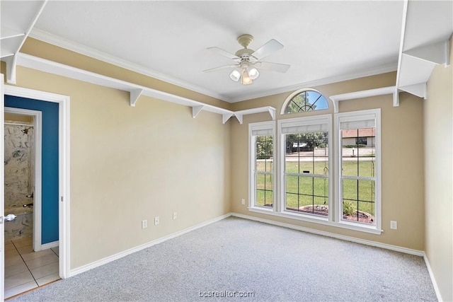 carpeted empty room featuring ceiling fan and ornamental molding