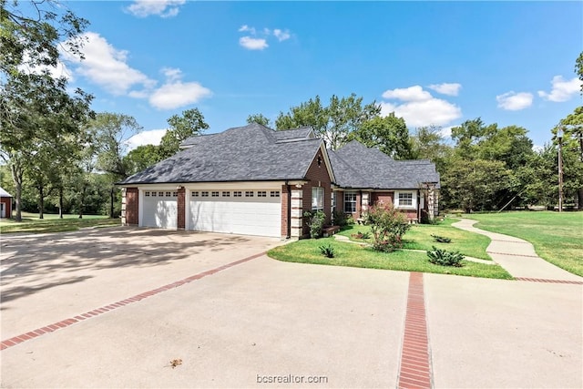 view of front facade with a front yard and a garage