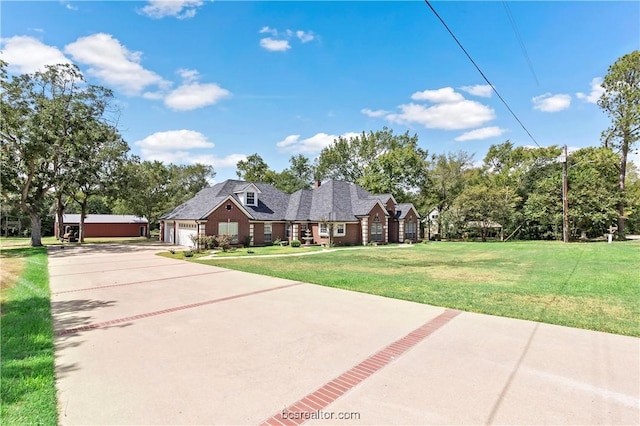 view of front of property with a front yard and a garage