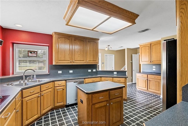 kitchen featuring a center island, sink, and appliances with stainless steel finishes