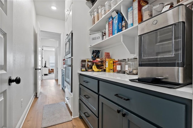 interior space with stainless steel appliances, recessed lighting, light wood-style flooring, and baseboards