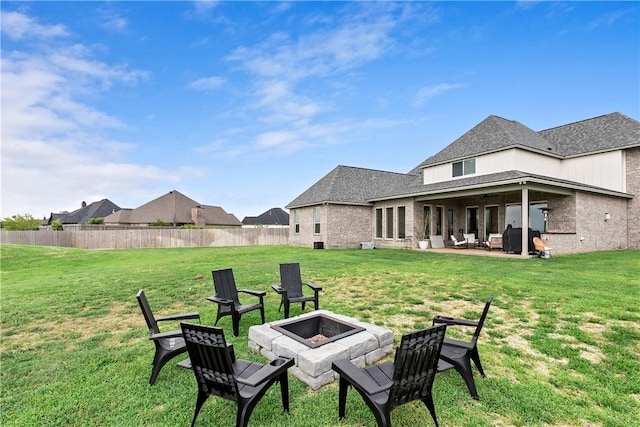 view of yard with a patio area, a fire pit, and fence