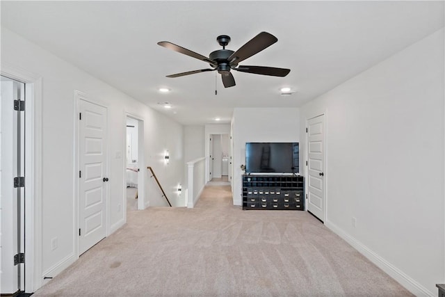unfurnished living room with baseboards, ceiling fan, and carpet floors
