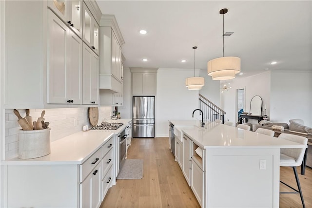 kitchen with recessed lighting, stainless steel appliances, a kitchen bar, tasteful backsplash, and light countertops