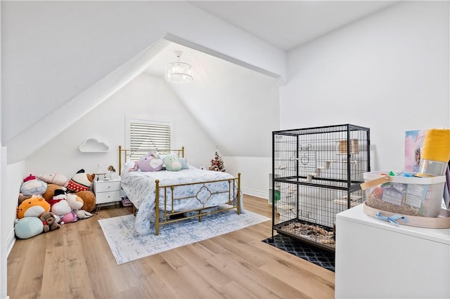 bedroom featuring vaulted ceiling and wood finished floors