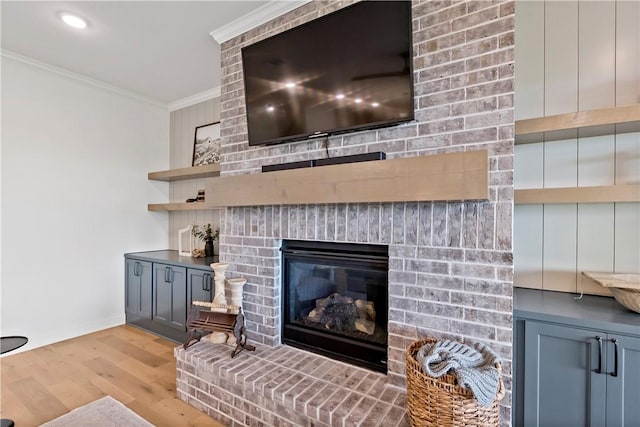 interior details featuring baseboards, wood finished floors, a fireplace, and crown molding