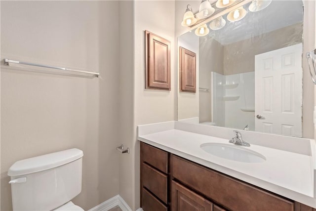 bathroom with a shower, vanity, and toilet